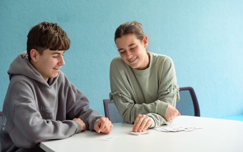 Two teenage students working through practice cards together